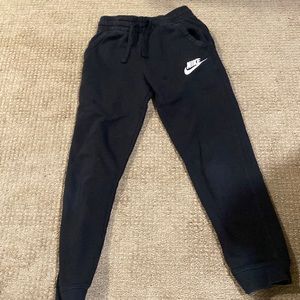 Girls Nike sweatpants, size medium, black, does have small hole.